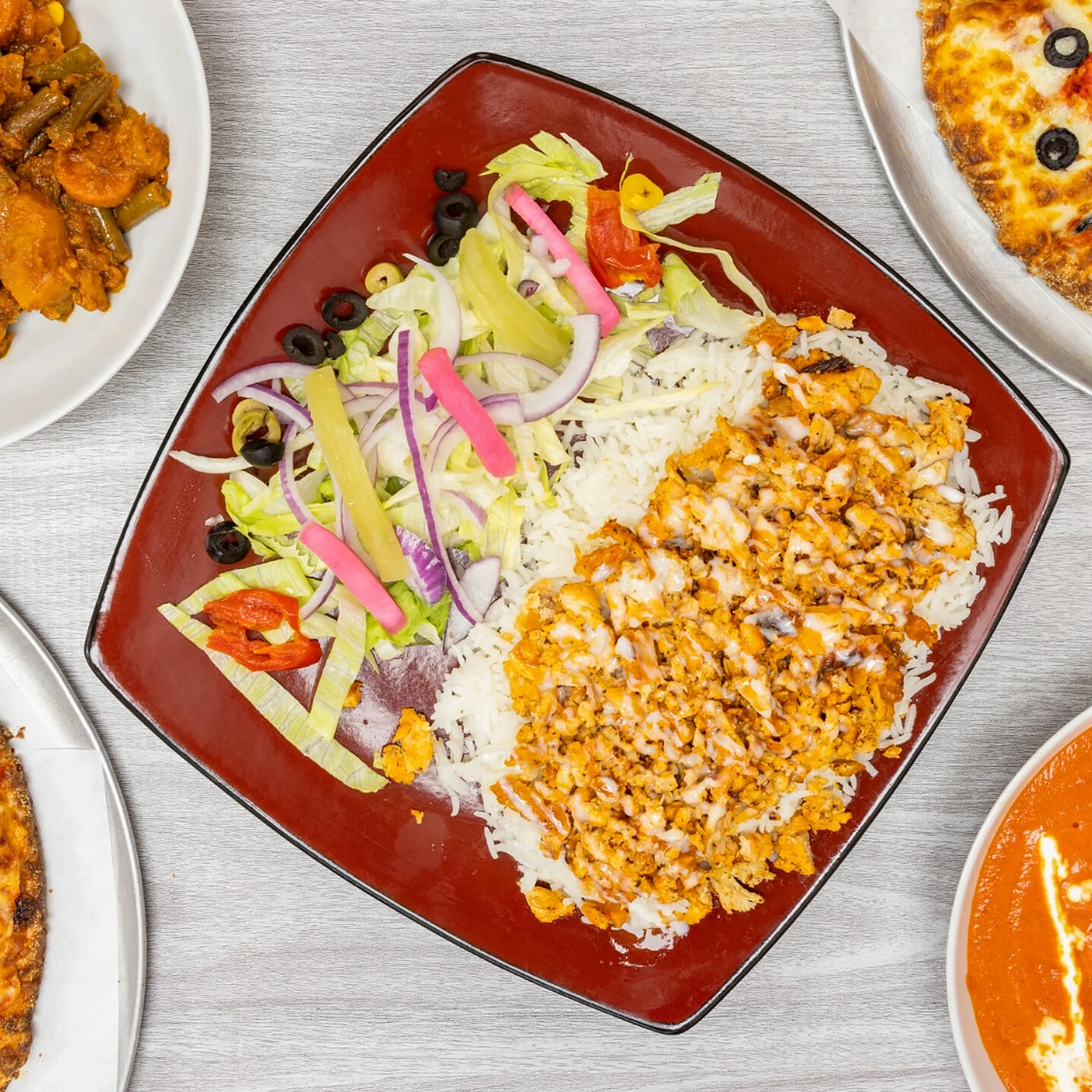 Pizza, butter chicken and donair platter spread from Great Canadian Pizza & Butter Chicken Hut - Macleod on Macleod Trail in Calgary