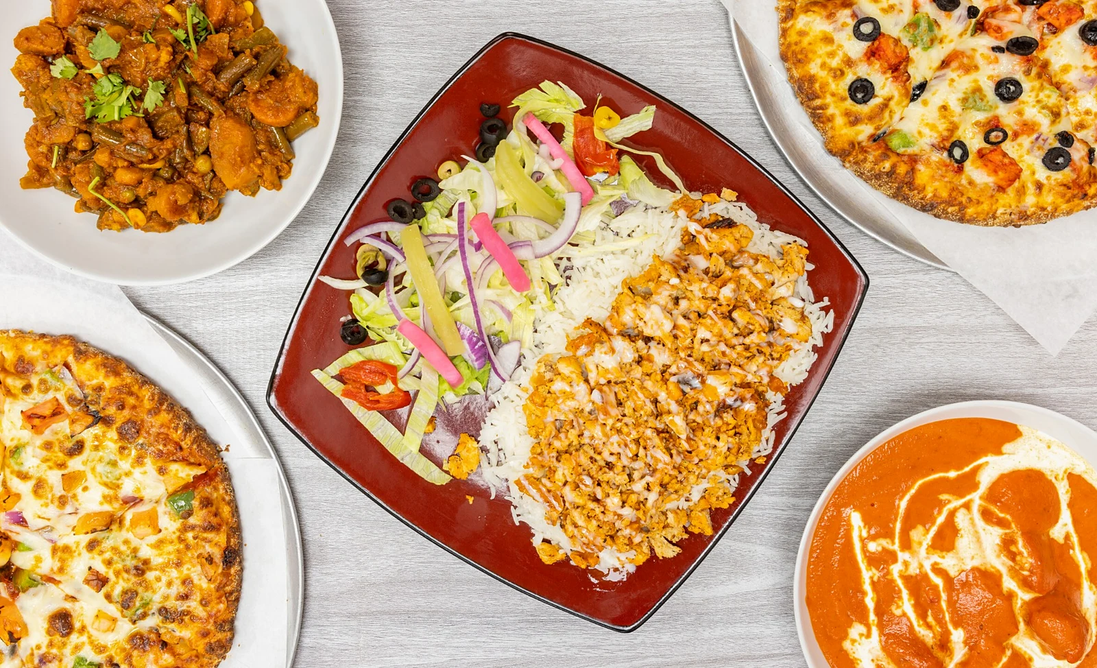 Pizza, butter chicken and donair platter spread from Great Canadian Pizza & Butter Chicken Hut - Macleod on Macleod Trail in Calgary, Alberta